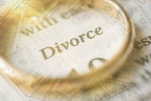 Wedding rings and financial documents representing divorce costs in Keller, TX