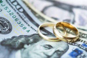 Wedding rings and cash representing the cost of divorce in Grapevine, TX