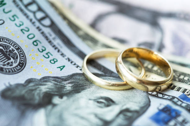 Wedding rings and cash representing the cost of divorce in Grapevine, TX